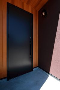 レッドシダーをドア廻りに使用。外壁と木の組み合わせがおしゃれな玄関ポーチ
